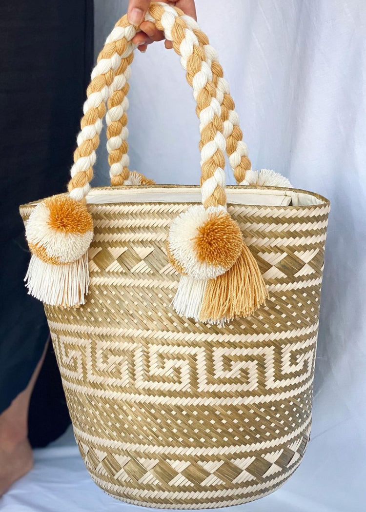 Handcrafted bag with decorative pom poms